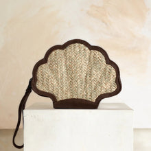 Load image into Gallery viewer, Shell-shaped clutch bag made of woven material on a white pedestal with a neutral background