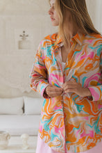 Load image into Gallery viewer, Woman wearing a colorful patterned shirt in a bright room