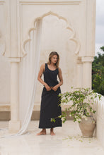 Load image into Gallery viewer, Woman wearing a black maxi skirt and tank top in a marble interior setting