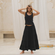 Load image into Gallery viewer, Woman wearing a black tiered skirt and tank top in a marble interior setting