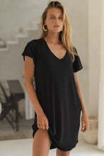 Load image into Gallery viewer, Woman wearing a black mini dress in an indoor setting
