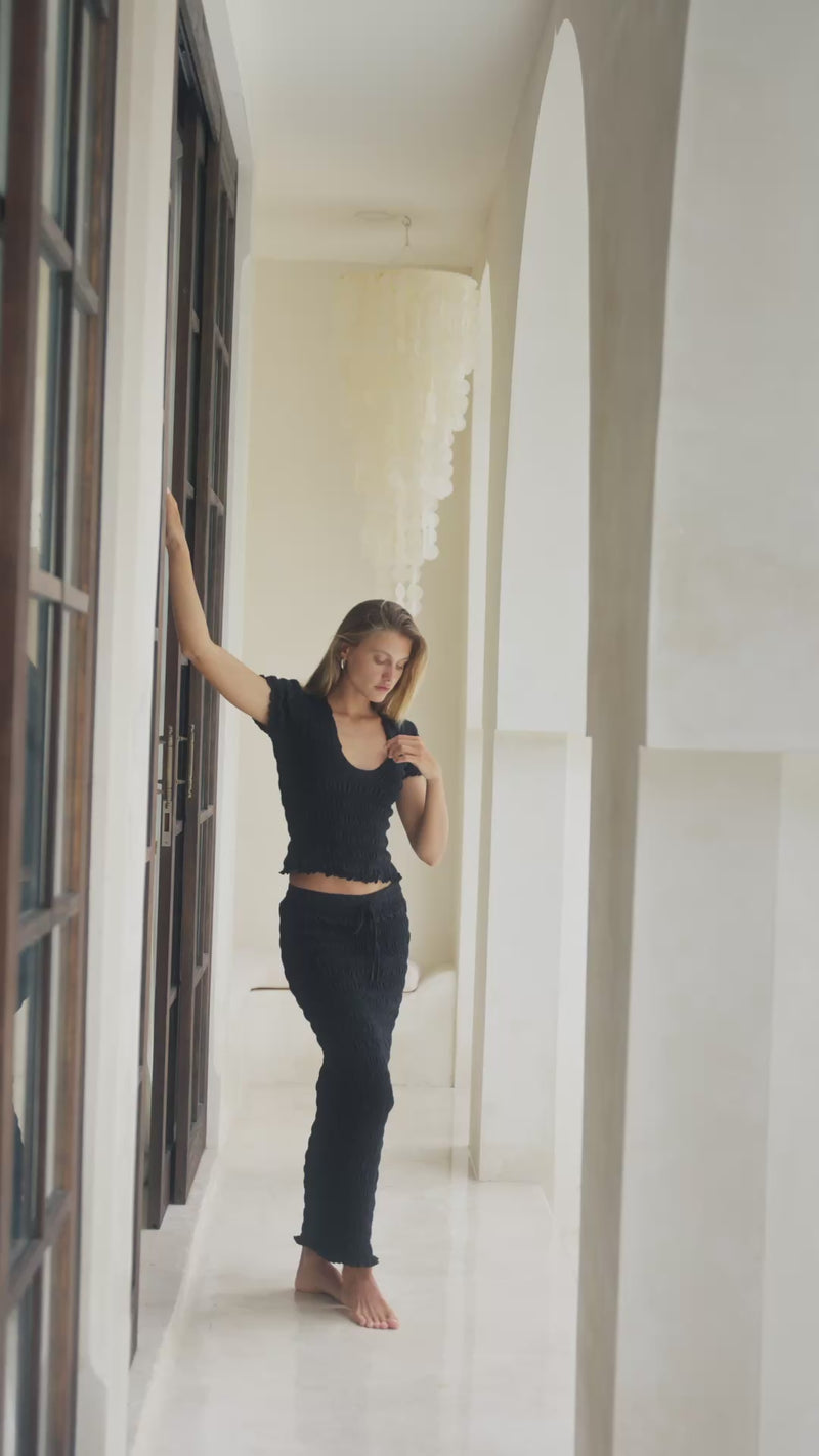 woman in black shirred top and shirred maxi skirt