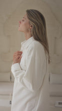 Load and play video in Gallery viewer, Woman wearing a white corduroy jacket and pink shorts against a neutral background
